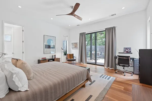 a spacious bedroom with a bed and a book shelf