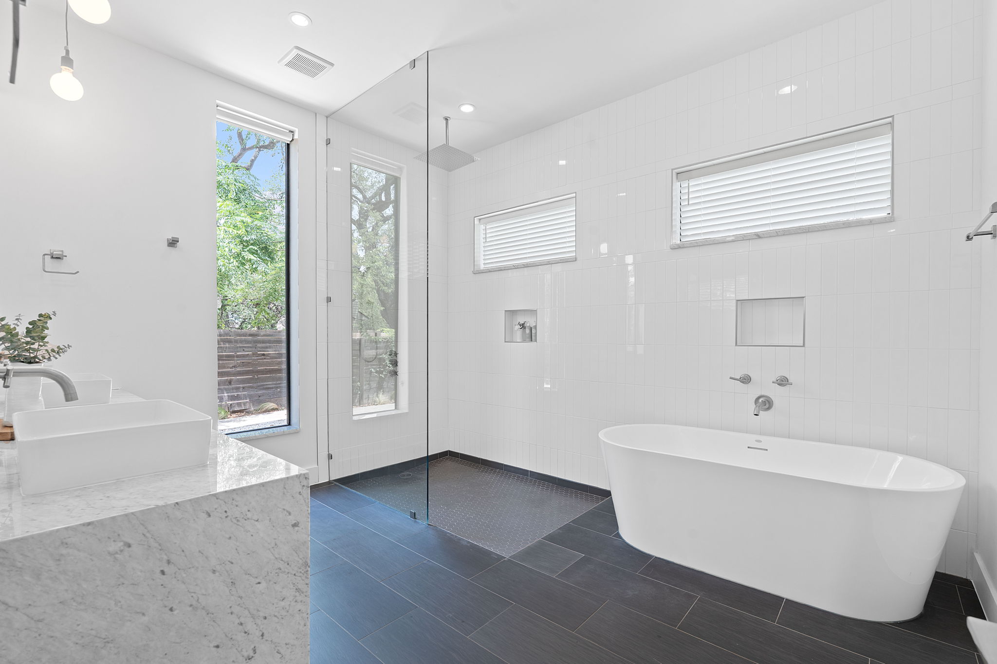 1605 Chelsea Lane Austin, TX 78704 - Photo 12 of 40 Bathroom with a freestanding bath, walk in shower, tile walls, double vanity, and tile patterned flooring
