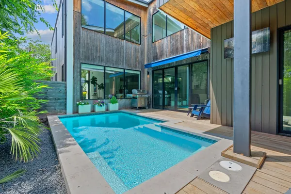 a view of a backyard with porch and patio