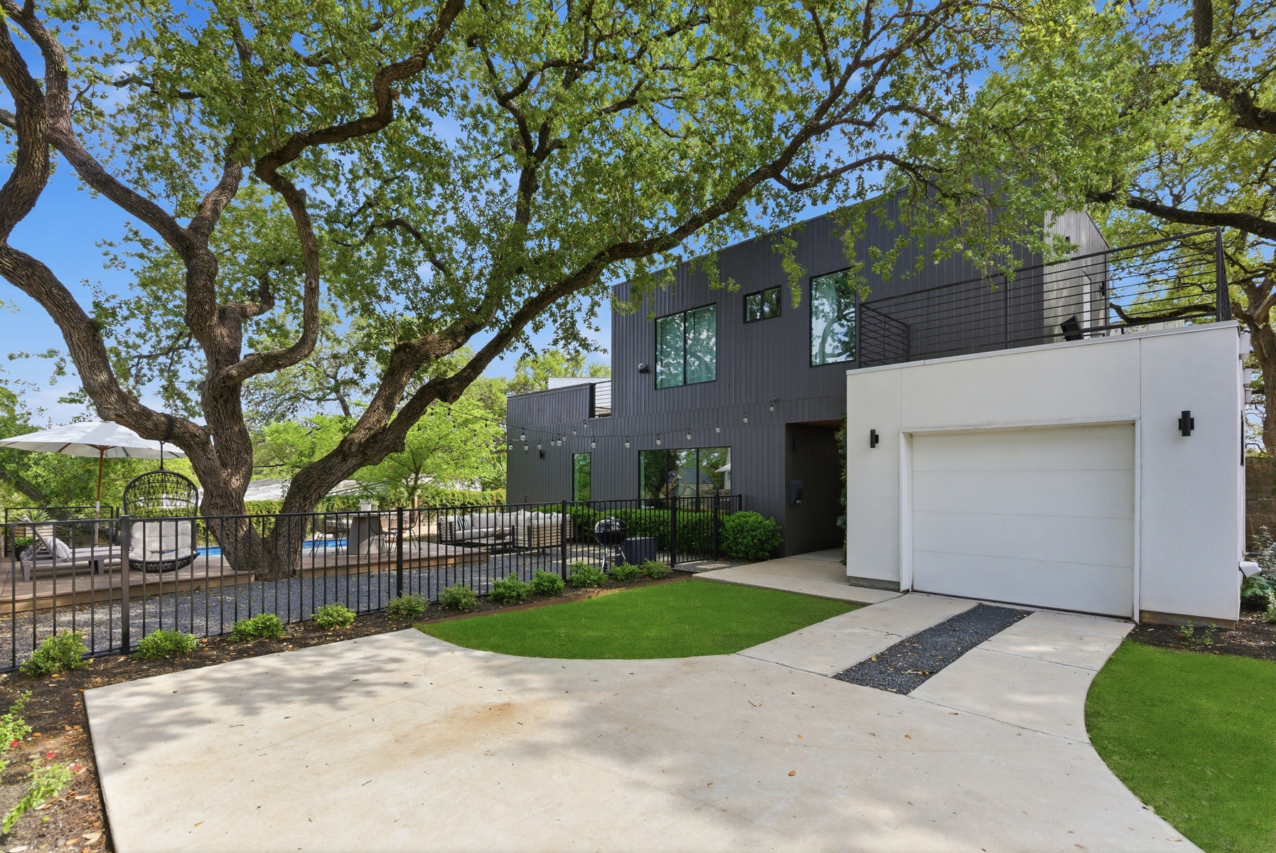 1605 Chelsea Lane Austin, TX 78704 - Photo 30 of 40 a view of a white house next to a yard with big trees