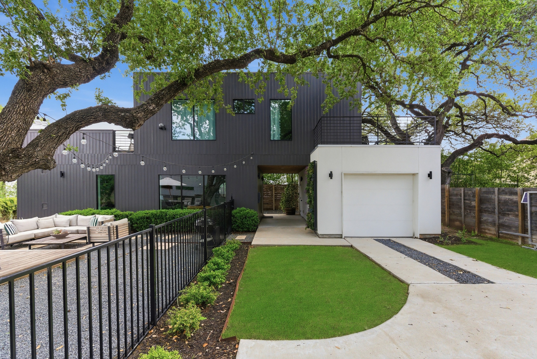 1605 Chelsea Lane Austin, TX 78704 - Photo 31 of 40 a view of a house with a small yard plants and a large tree