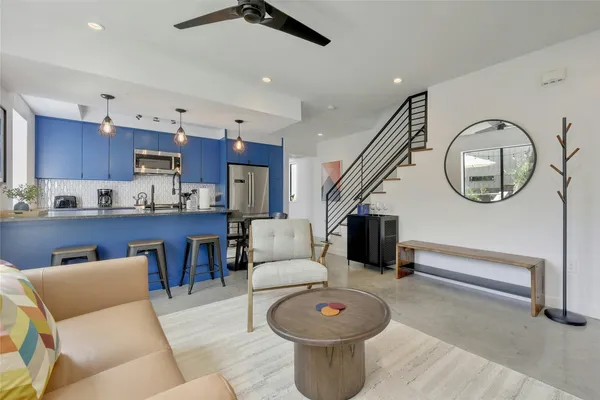 a living room with furniture and a wooden floor