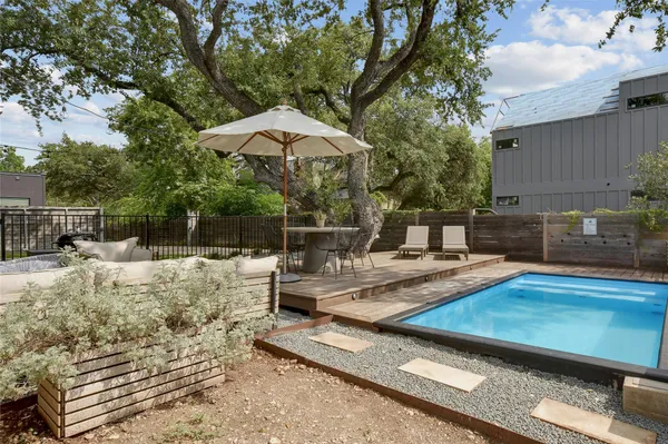 a view of a backyard with sitting area