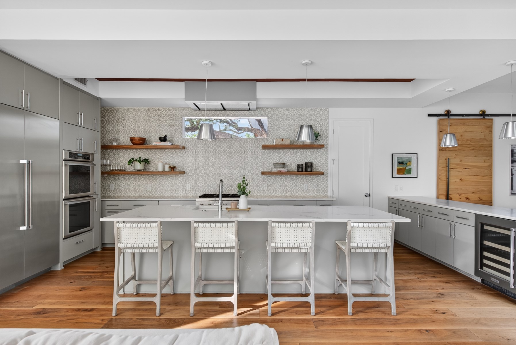 1605 Chelsea Lane Austin, TX 78704 - Photo 7 of 40 a kitchen with stainless steel appliances a table and chairs in it