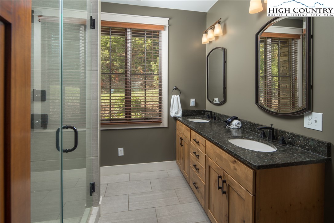 1253 Goldenrod Road Boone, NC 28607 - Photo 15 of 48 a bathroom with a double vanity sink and a mirror