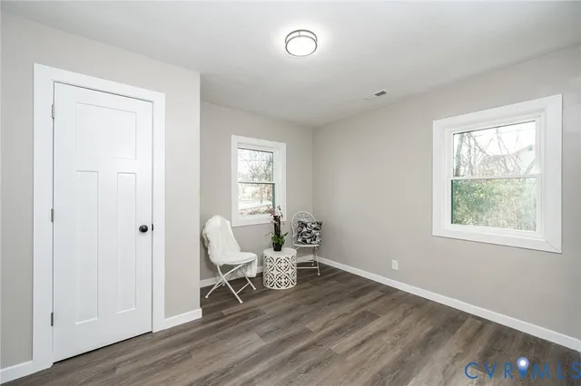 a view of a hallway with wooden floor and glass door