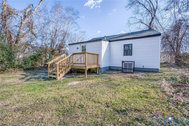 a view of a house with a yard and sitting area