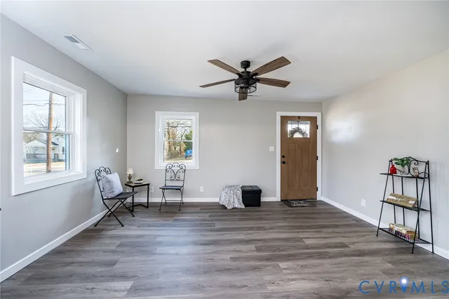a view of empty room with wooden floor