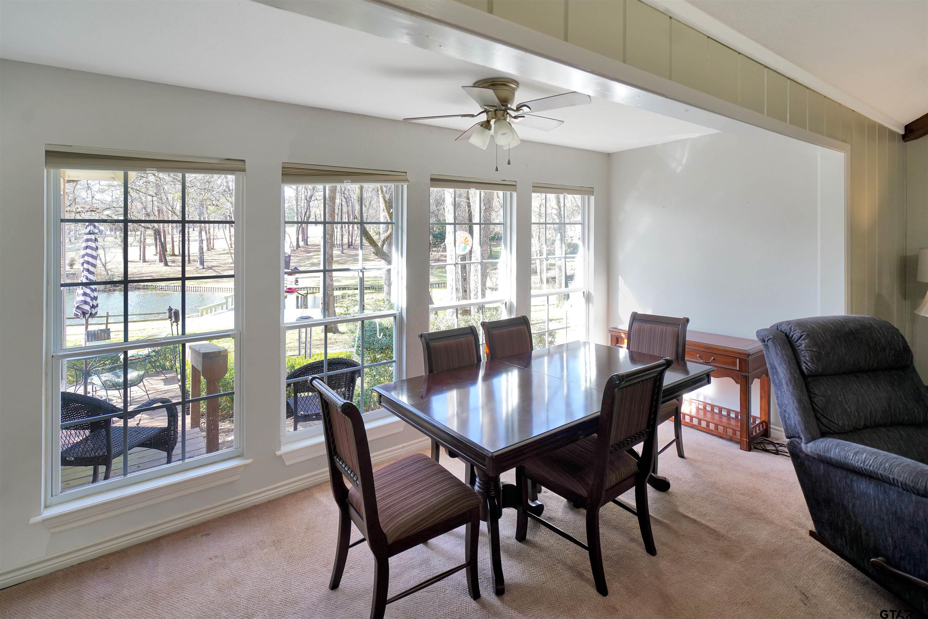 120 Rainbow Cove Holly Lake Ranch, TX 75765 - Photo 13 of 39 a view of a dining room with furniture wooden floor and a chandelier