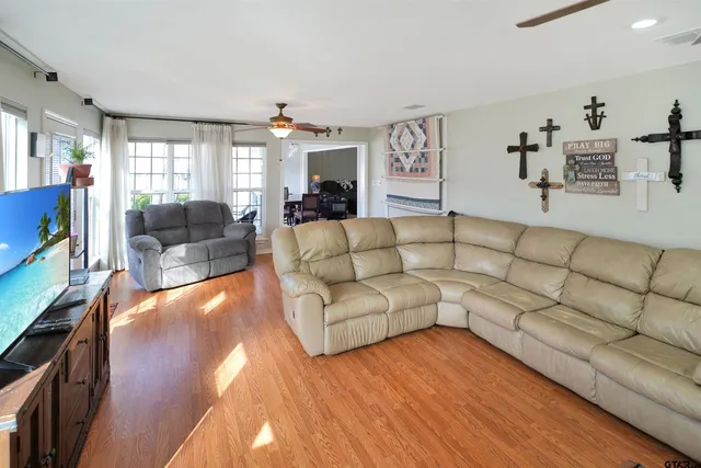 a living room with furniture and a wooden floor