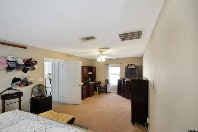 a view of a kitchen with refrigerator and window