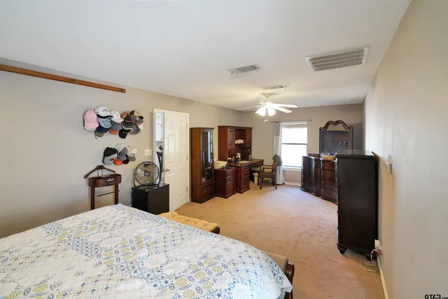 a bed room with a bed and a television