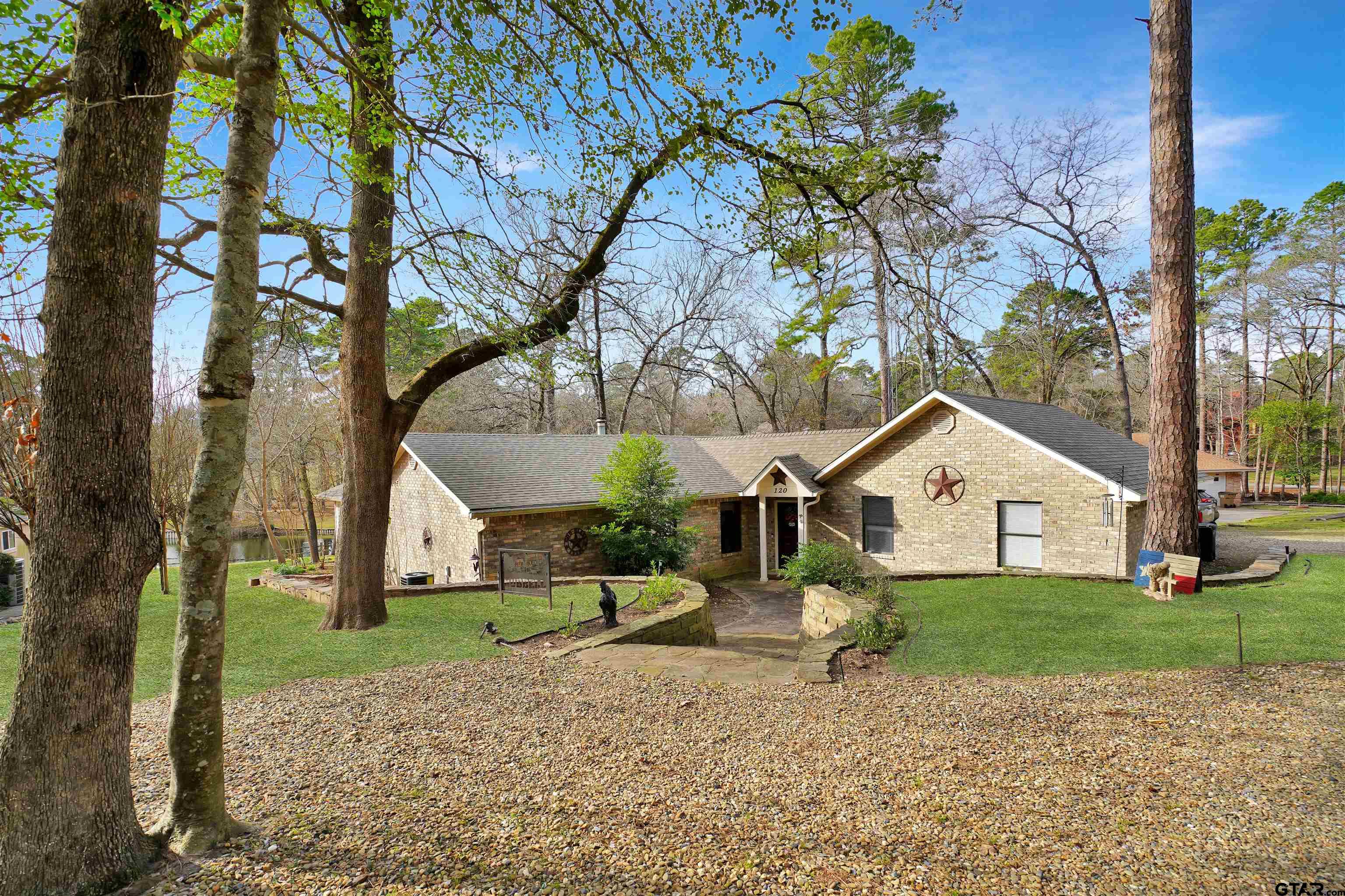 120 Rainbow Cove Holly Lake Ranch, TX 75765 - Photo 2 of 39 a view of a house with a tree in the background