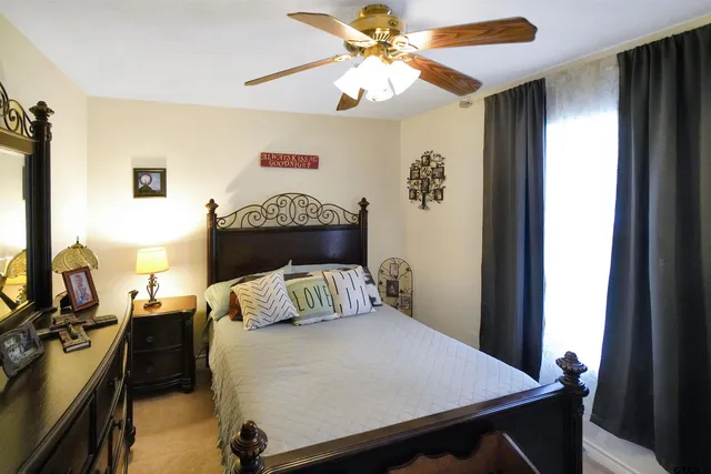 a bedroom with a bed and a chandelier