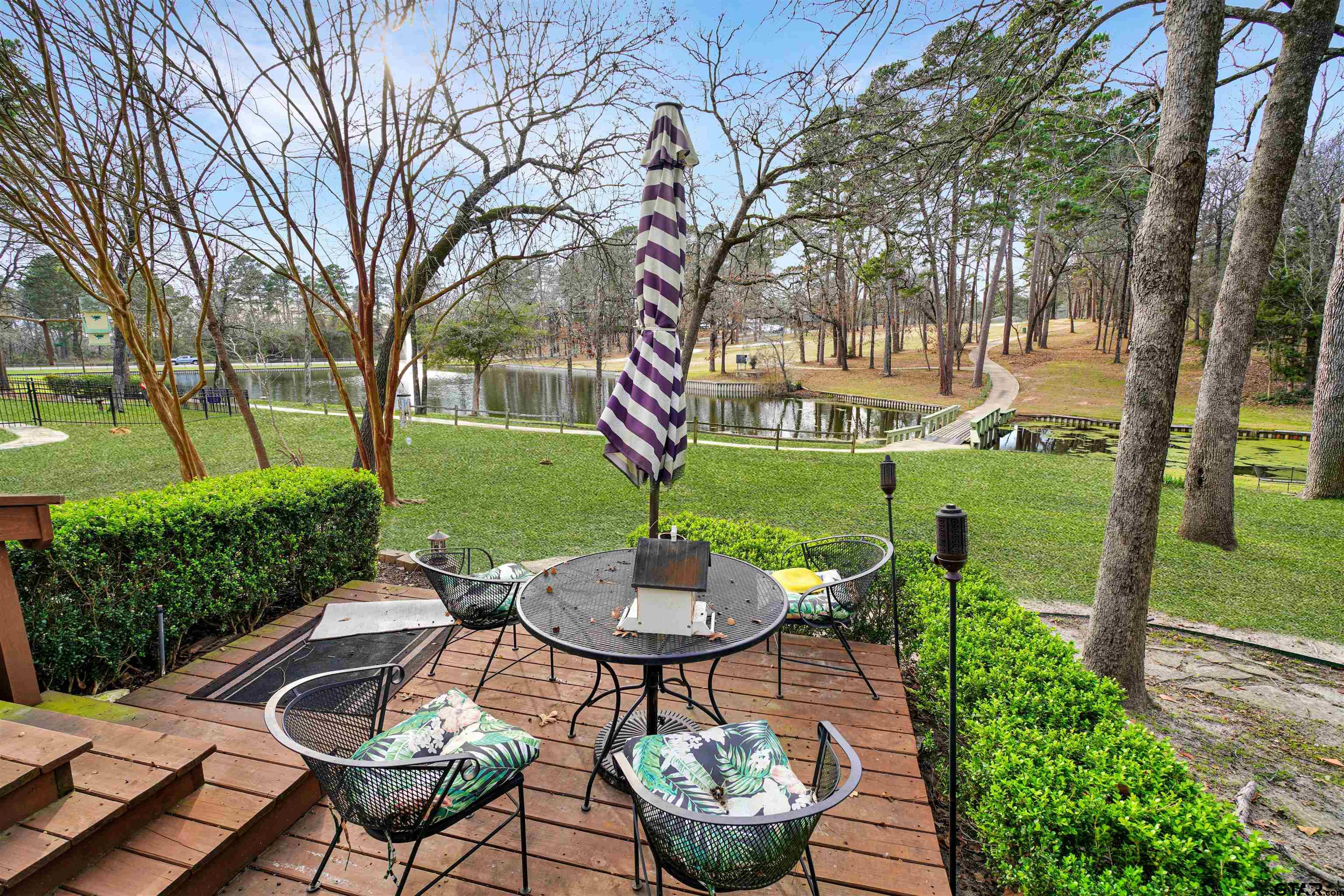120 Rainbow Cove Holly Lake Ranch, TX 75765 - Photo 29 of 39 a view of a patio with table and chairs potted plants and a large tree