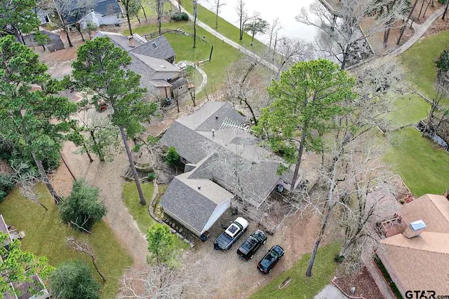 an aerial view of a house with a yard