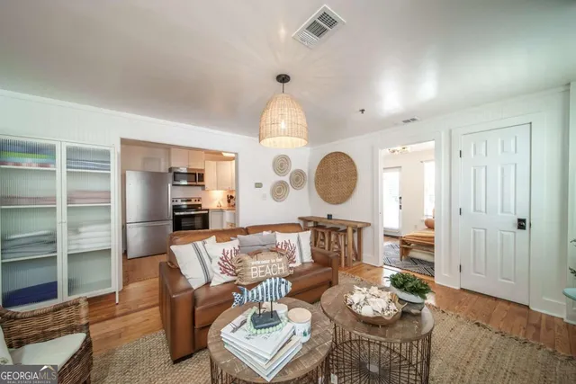 a living room with furniture and wooden floor