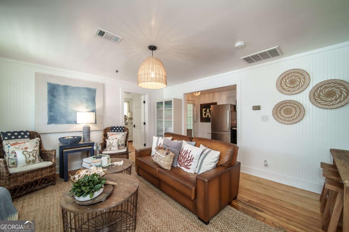 1413 2nd Avenue, Unit 2 Tybee Island, GA 31328 - Photo 14 of 30 a living room with furniture and a large window