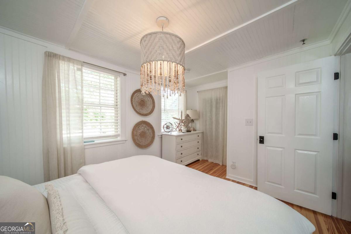 1413 2nd Avenue, Unit 2 Tybee Island, GA 31328 - Photo 18 of 30 a bedroom with bed and a window