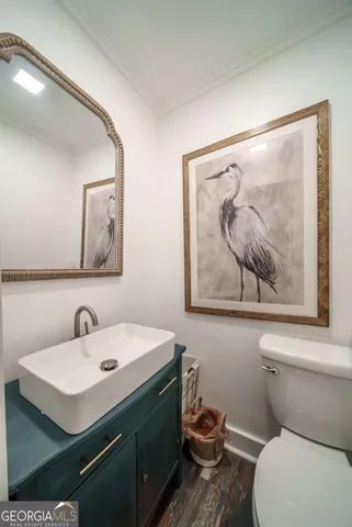 a bathroom with a sink mirror and toilet