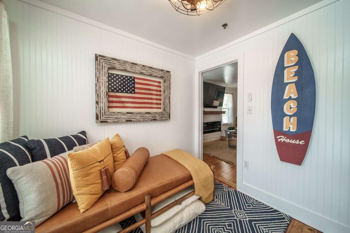 1413 2nd Avenue, Unit 2 Tybee Island, GA 31328 - Photo 21 of 30 a bedroom with furniture and a wooden floor