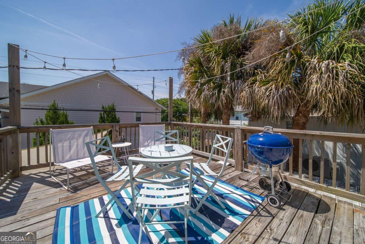 1413 2nd Avenue, Unit 2 Tybee Island, GA 31328 - Photo 23 of 30 a view of a table and chairs on the roof deck