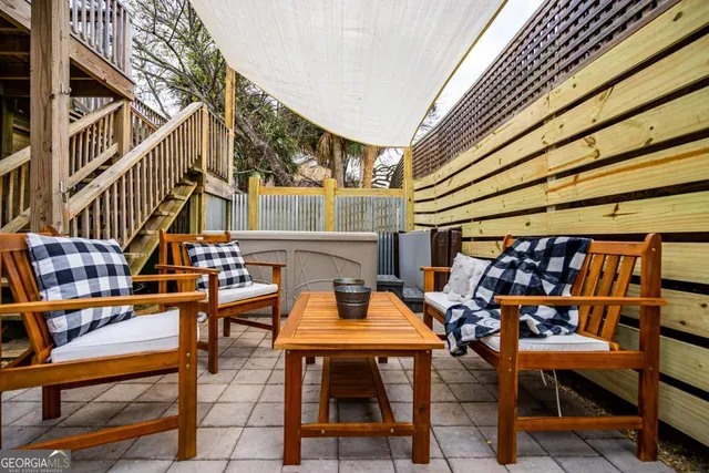 a view of a patio with a table and chairs