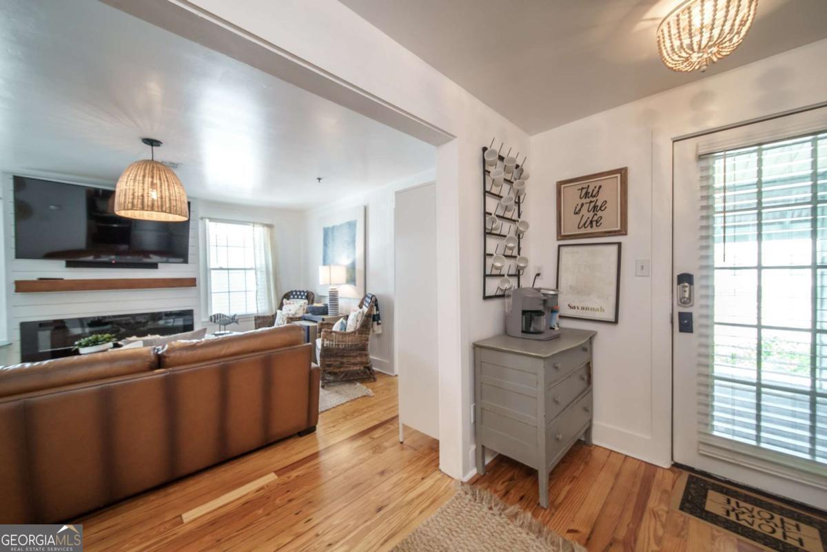1413 2nd Avenue, Unit 2 Tybee Island, GA 31328 - Photo 9 of 30 a kitchen with stainless steel appliances a stove top oven and a refrigerator