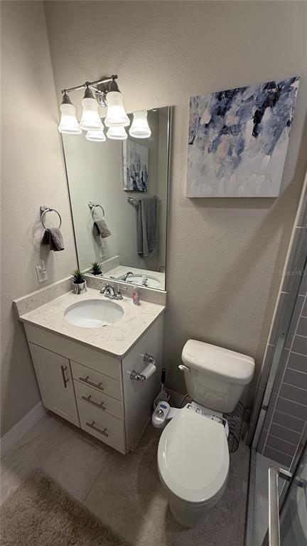 7718 Sweet Star Avenue Orlando, FL 32836 - Photo 11 of 51 a bathroom with a toilet sink and mirror