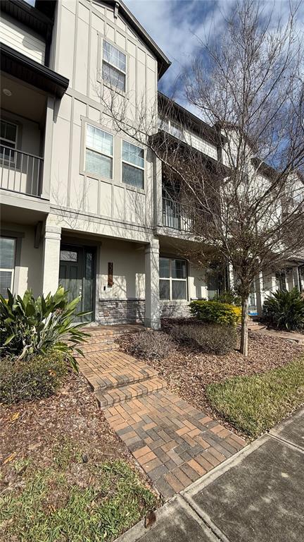7718 Sweet Star Avenue Orlando, FL 32836 - Photo 2 of 51 a front view of a building with a yard