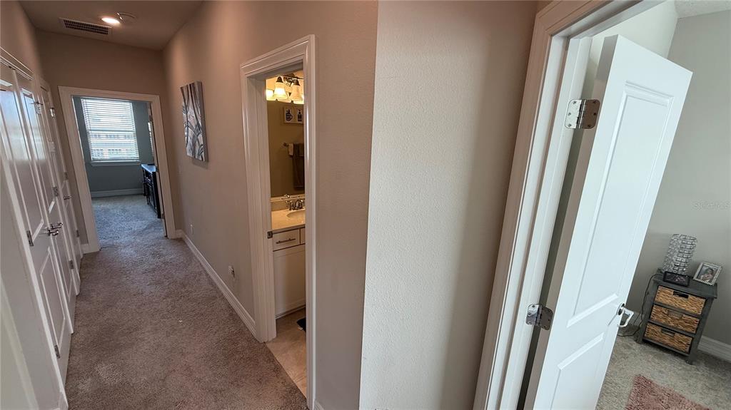 7718 Sweet Star Avenue Orlando, FL 32836 - Photo 29 of 51 a view of a hallway with wooden floor and stairs