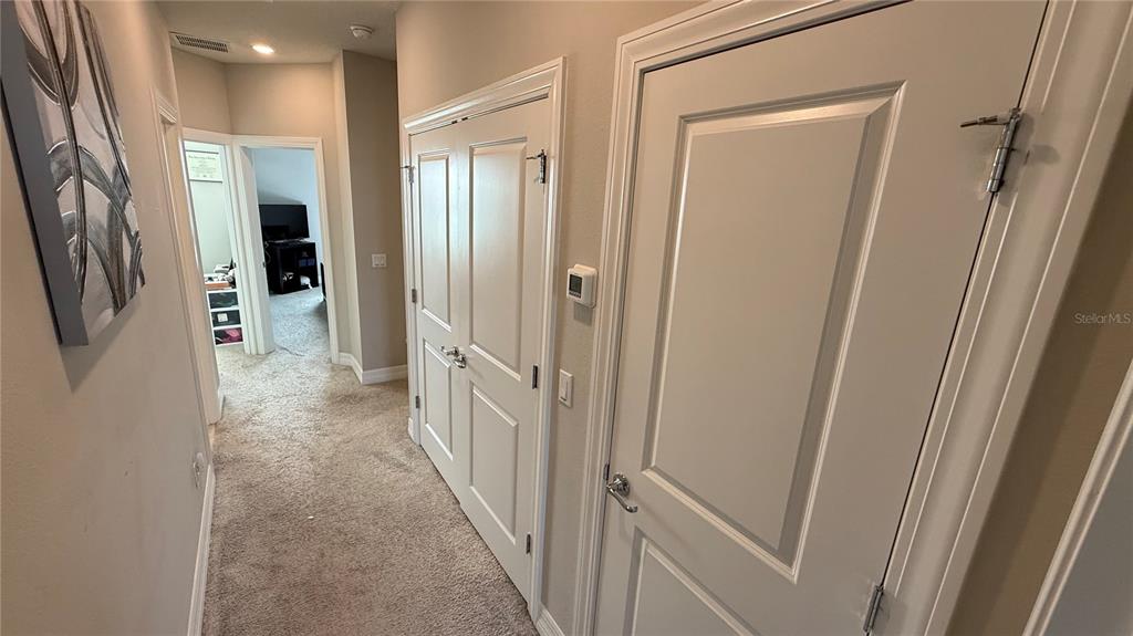 7718 Sweet Star Avenue Orlando, FL 32836 - Photo 39 of 51 a view of a hallway with wooden shelves