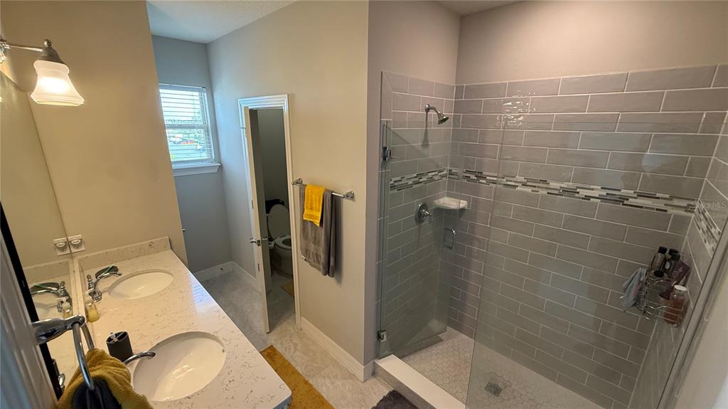 7718 Sweet Star Avenue Orlando, FL 32836 - Photo 45 of 51 a bathroom with a sink toilet and shower