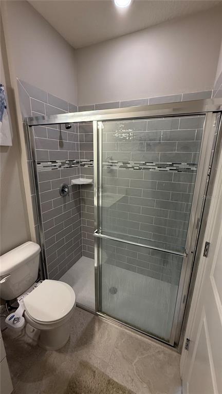 7718 Sweet Star Avenue Orlando, FL 32836 - Photo 10 of 51 a bathroom with a toilet and a shower