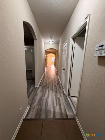a view of gallery with wooden floor