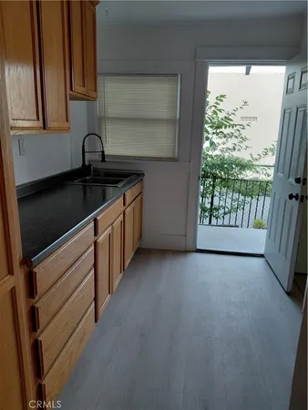 a kitchen with a sink and a large window