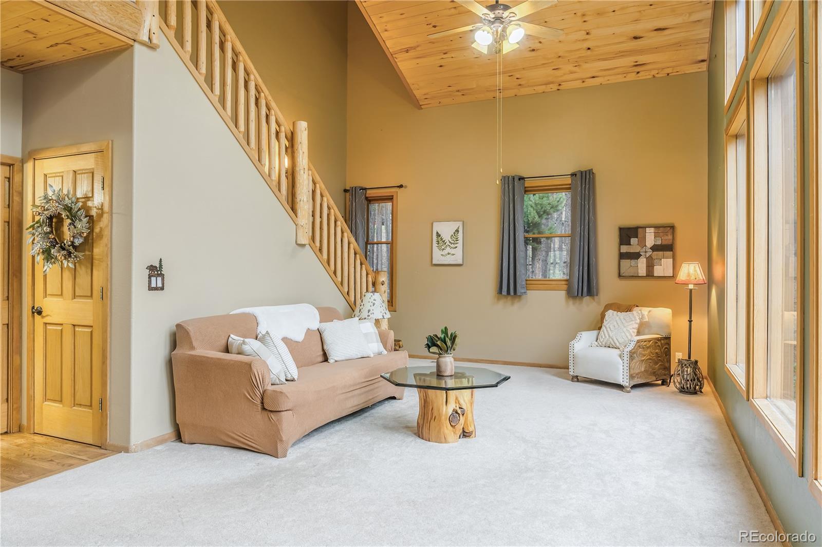 37 Juniper Court Evergreen, CO 80439 - Photo 14 of 44 a living room with furniture and stairs