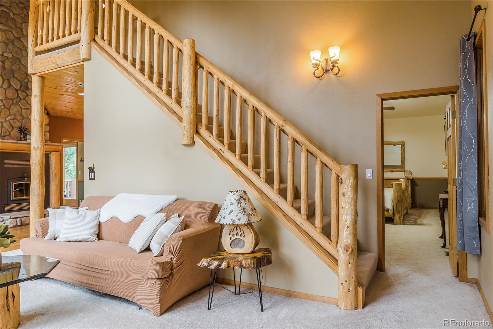 37 Juniper Court Evergreen, CO 80439 - Photo 17 of 44 a view of staircase with furniture and a chandelier