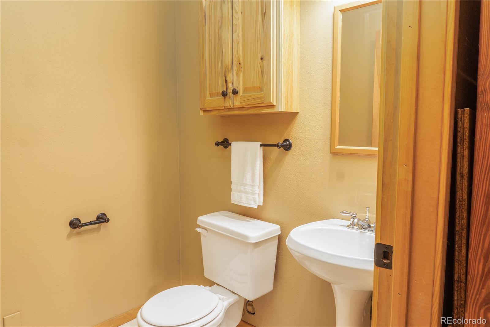 37 Juniper Court Evergreen, CO 80439 - Photo 36 of 44 a white toilet sitting next to a sink
