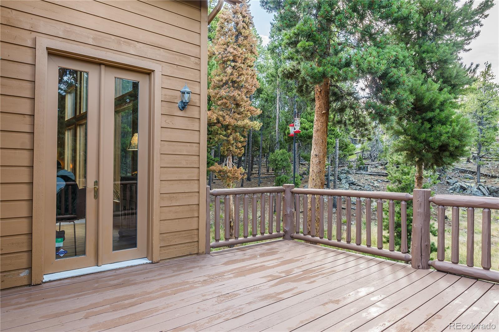 37 Juniper Court Evergreen, CO 80439 - Photo 39 of 44 a view of a deck with wooden floor and wooden fence