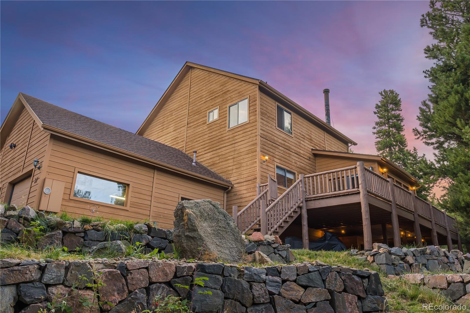 37 Juniper Court Evergreen, CO 80439 - Photo 5 of 44 a front view of a house with garden
