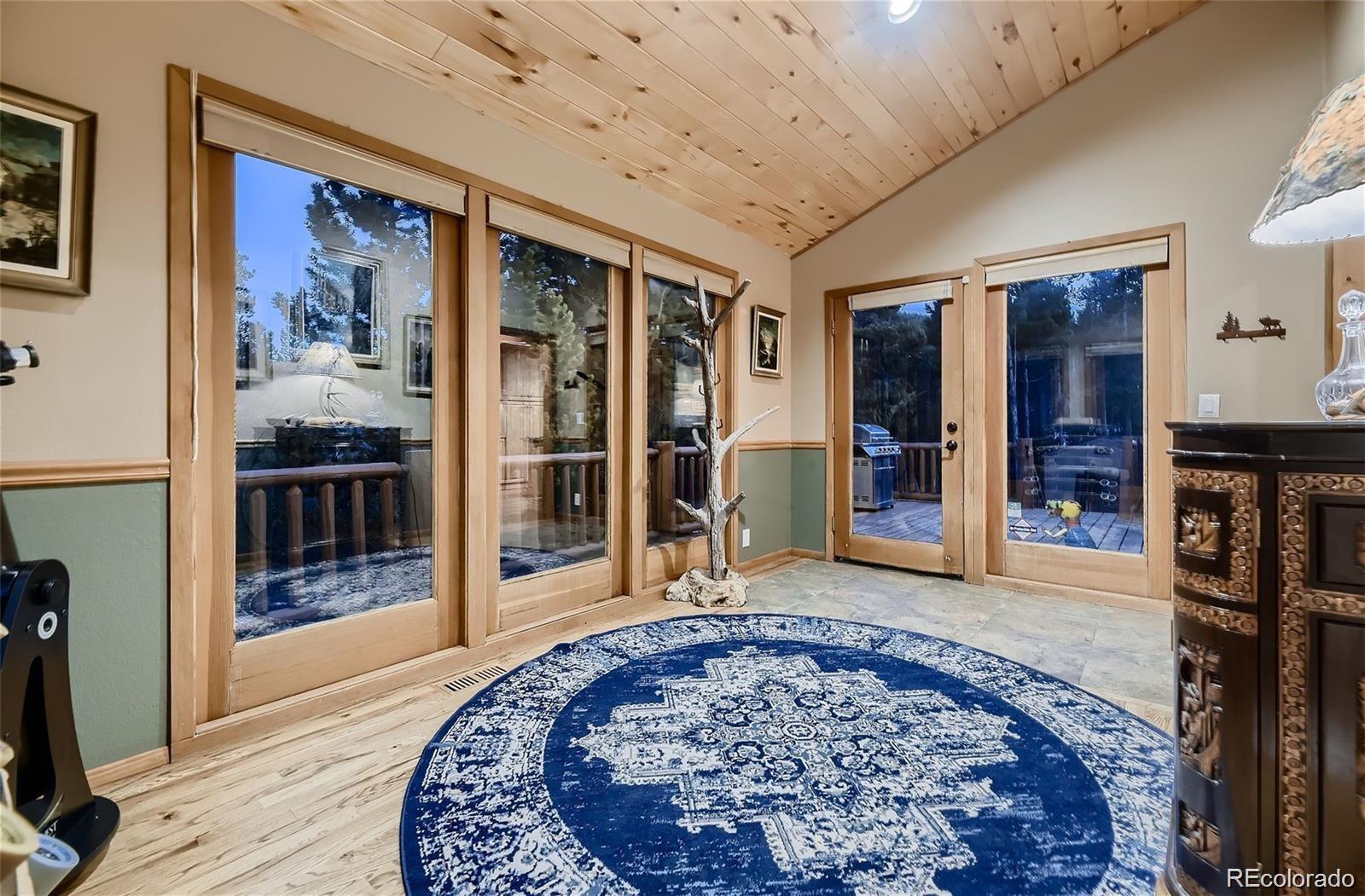37 Juniper Court Evergreen, CO 80439 - Photo 9 of 44 a view of a hallway with wooden floor and windows