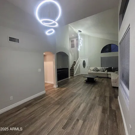 a living room with furniture and a wooden floor