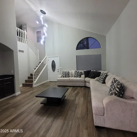 a living room with furniture and a wooden floor
