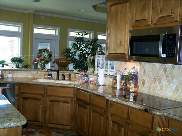 a kitchen with sink and cabinets