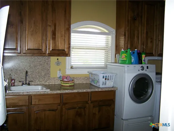 a kitchen with a sink cabinets and a window