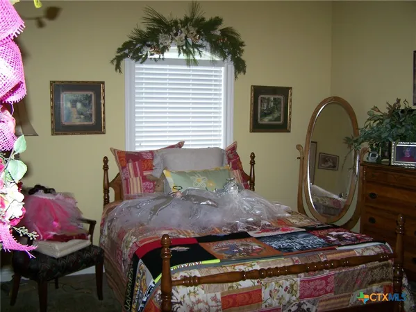 a bed sitting in a bedroom next to a window
