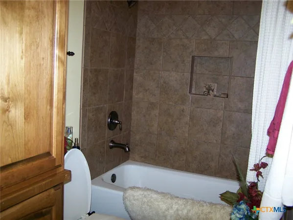 a bathroom with a tub and a shower
