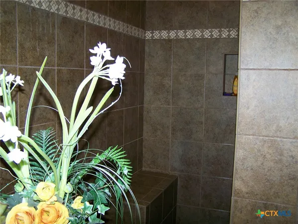 a vase of flowers sitting on a bathroom