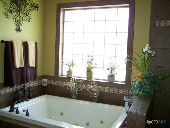 a bathroom with a bathtub and a window